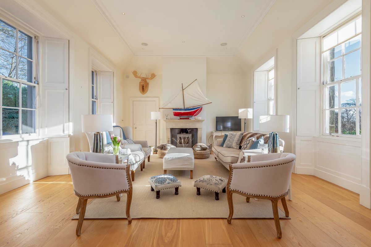 Old School House - sitting room with large windows on 2 sides